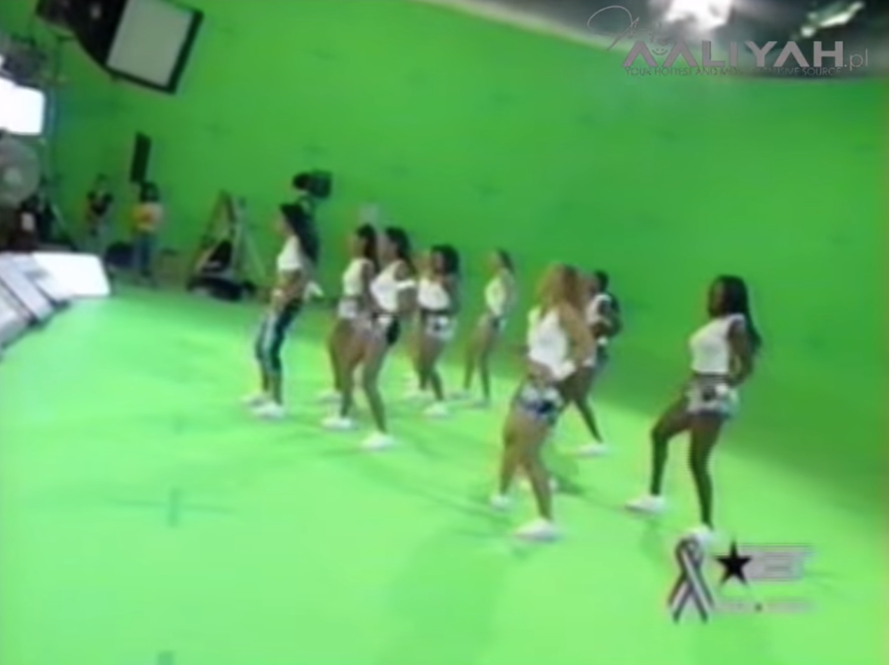 A group of women dancing in a green room

Description automatically generated