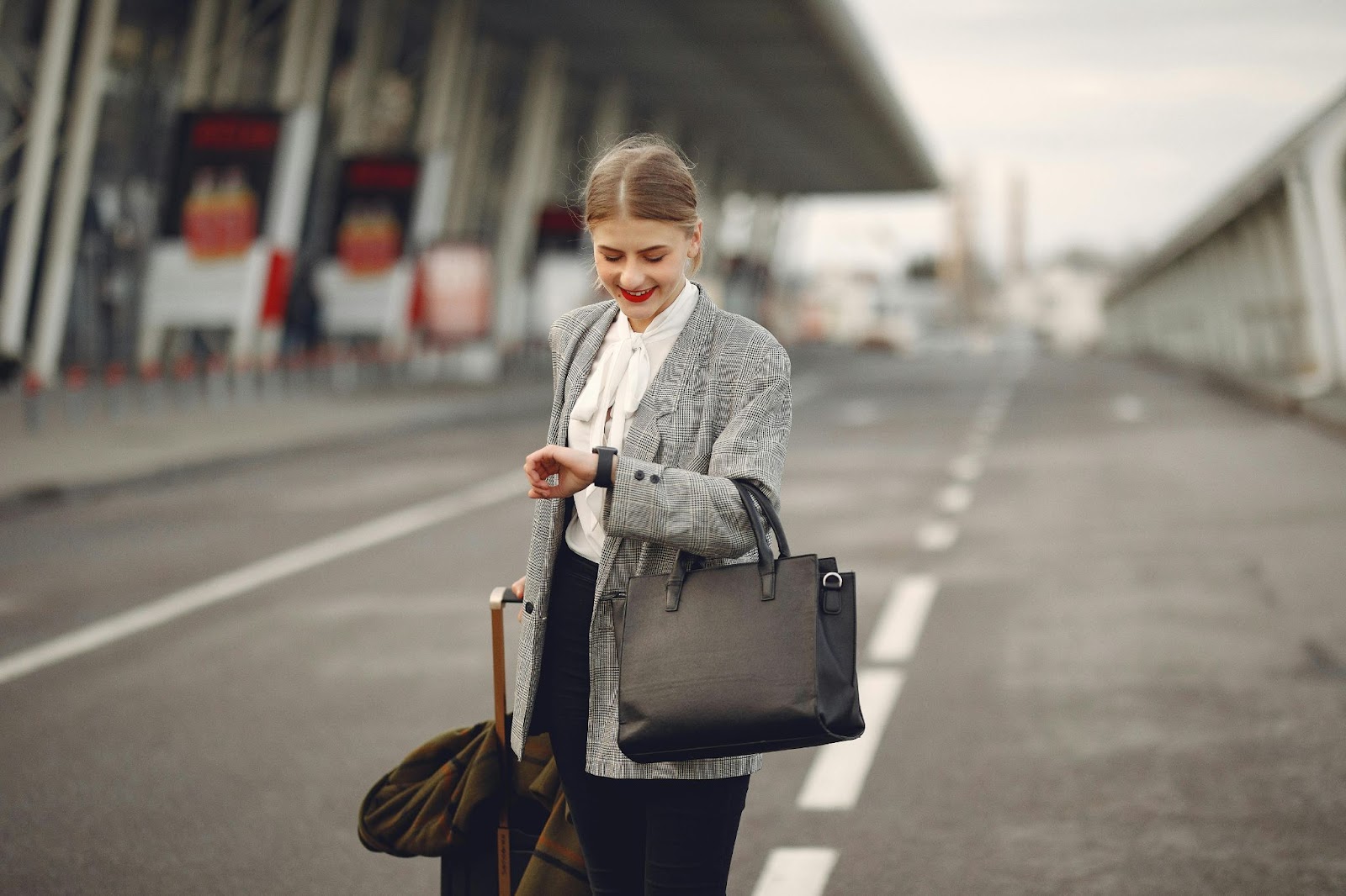 A woman checking her luxury watch before a flight. 