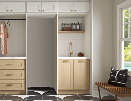 A laundry room showing an empty area where the washer and dryer go when stacked on top of each other.