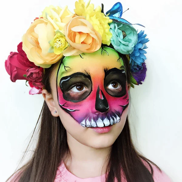 Picture of a young girl rocking the rainbow skull design