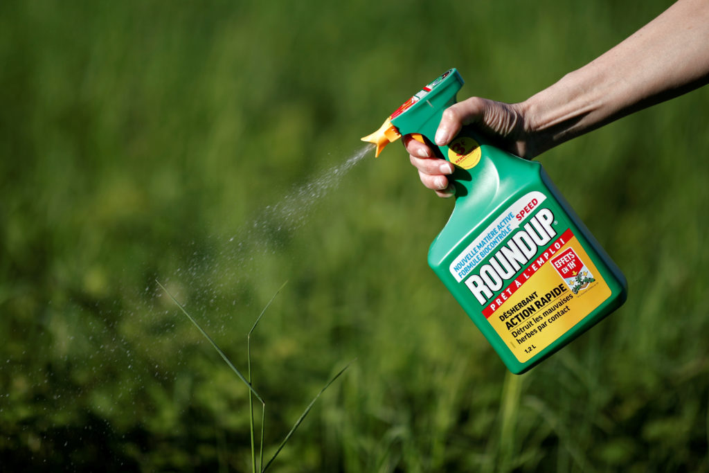 Image of a farmer spraying crops with glyphosate (roundup).