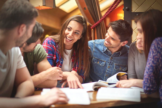 Friends sharing laughter while studying together.
