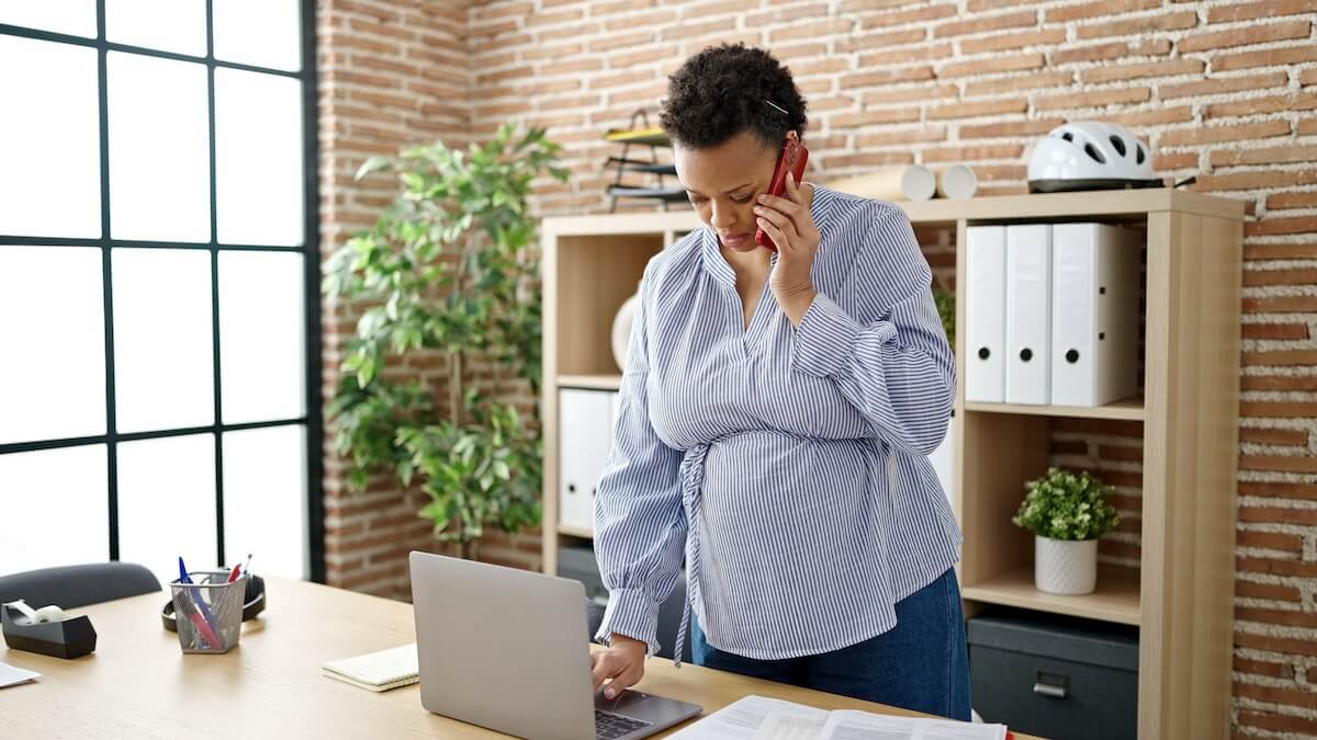 Pregnancy accommodations at work: pregnant manager talking on the phone