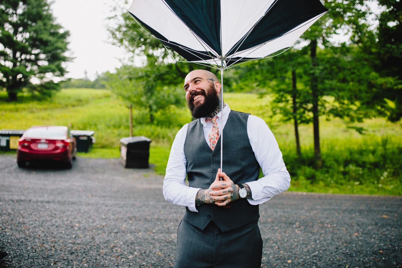 Someone holding an umbrella that has been turned inside out