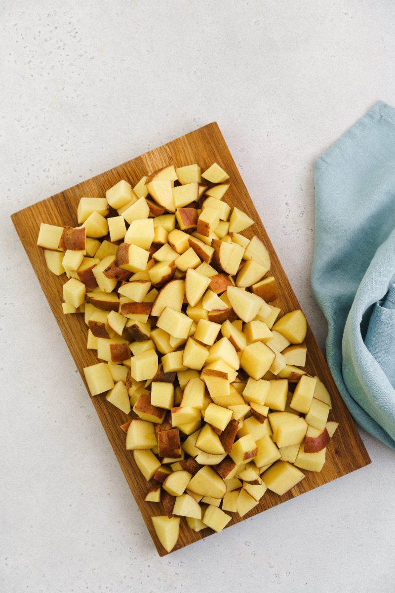 Red skin apples on a wooden cutting board.