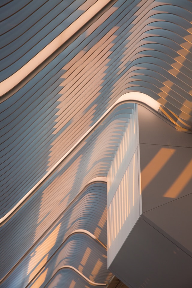 A curved metallic facade of a building designed using parametric design principles