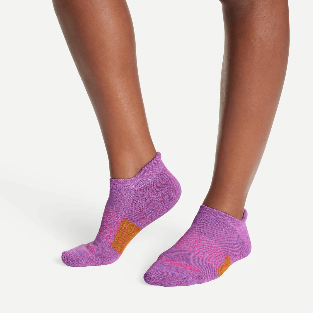 pink recycled socks from Bombas on a female model 