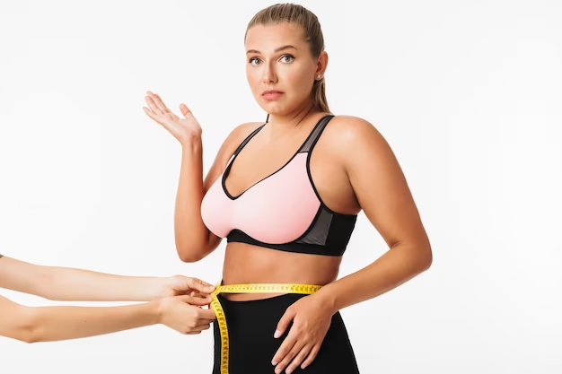 Young Woman Checking Her Waist Size With Help of A Friend