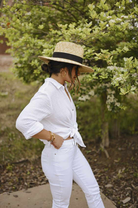 Lady rocks a white shiirt and trouser  with her Mexican hat 