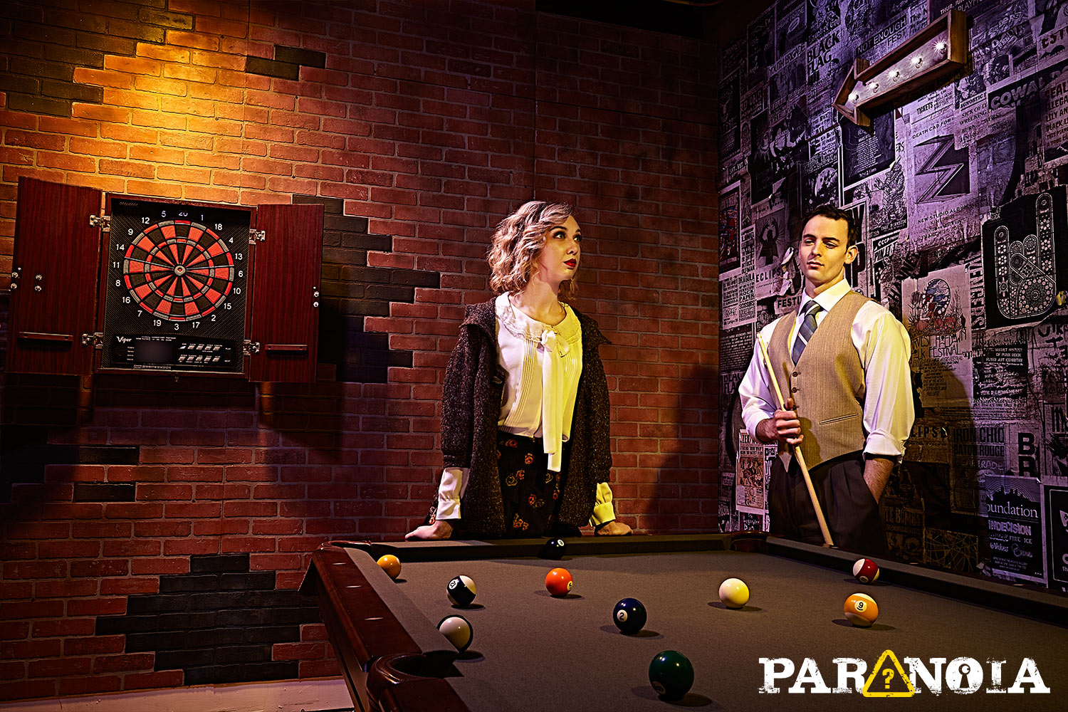 Animated image of two people trying to decipher escape room clues on a snooker table. 