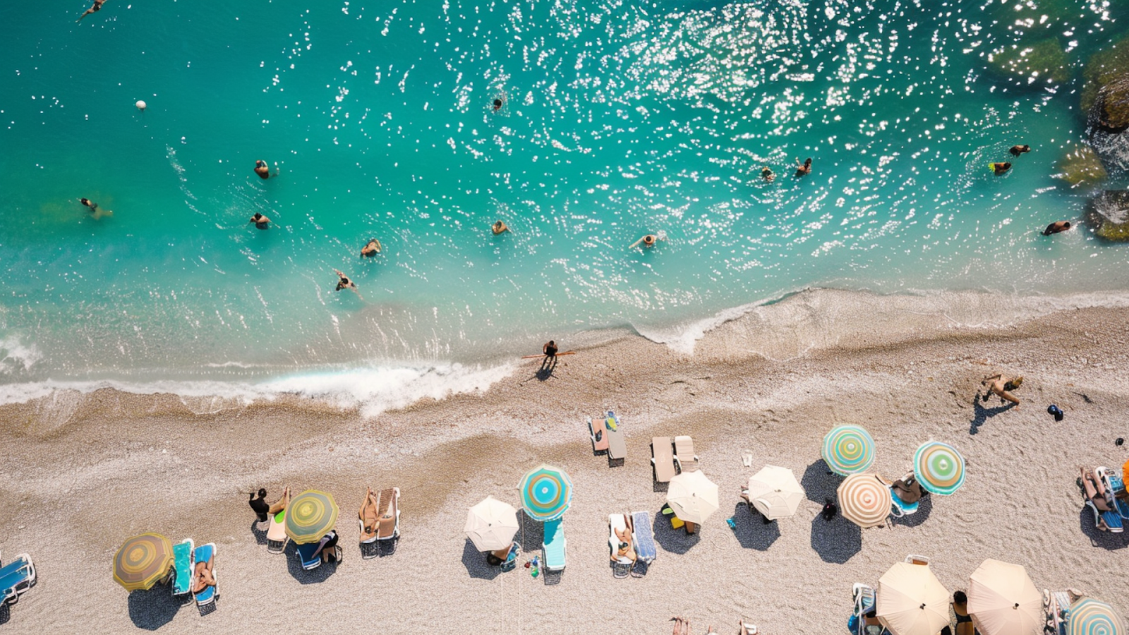 Aerial shot of people swimming and sunbathing on a beach in Nice, France