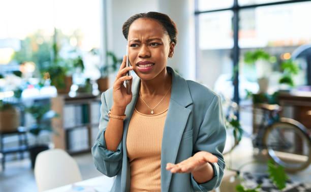 phone call, argument and woman with conflict in the office talking annoyed or angry on a cellphone. upset, moody and professional african employee fighting with boyfriend on a smartphone in workplace - black woman stress stock pictures, royalty-free photos & images
