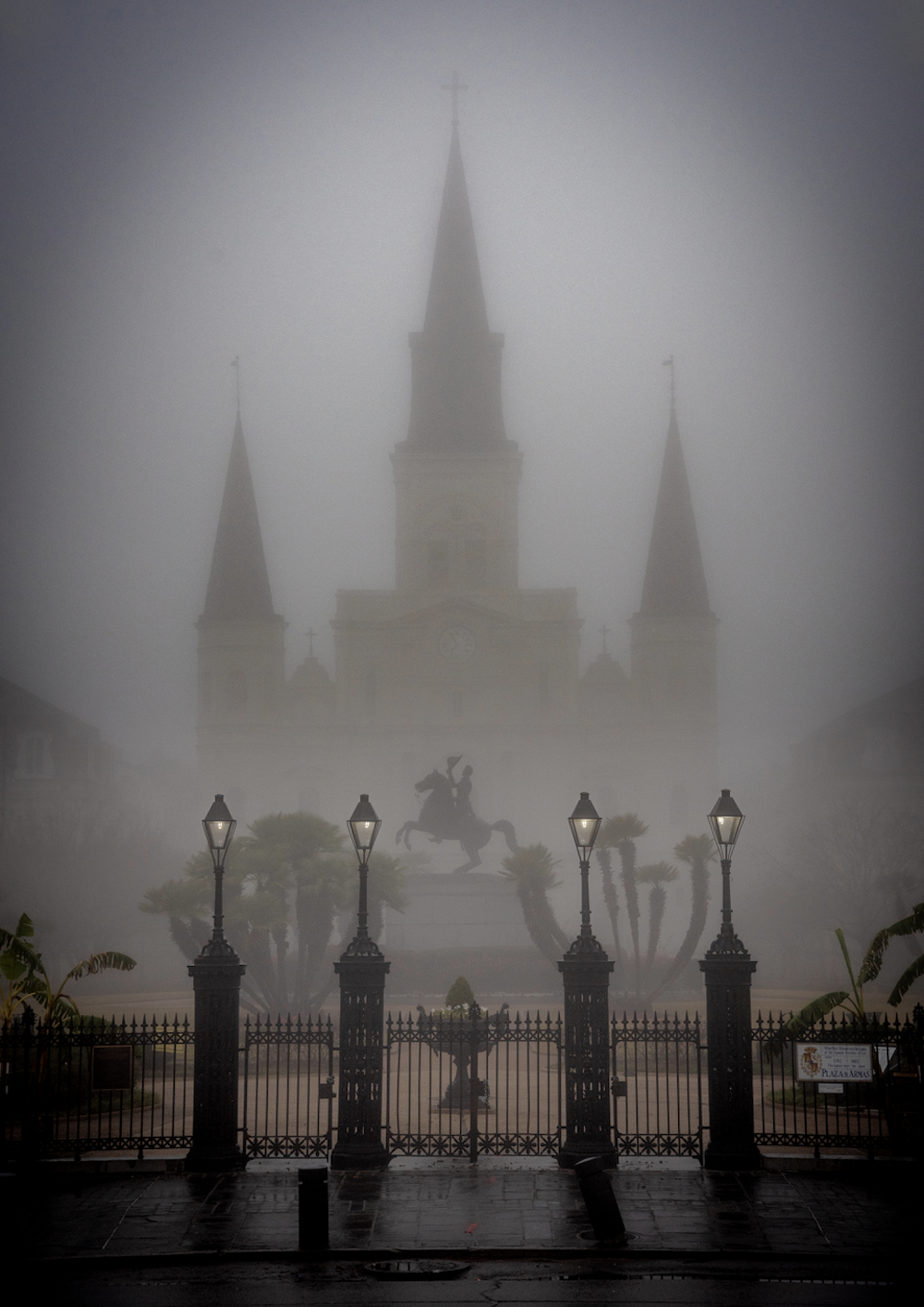 Large Gothic Building In Heavy Fog With Gated Fence