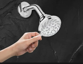 A hand opening a shower head

Description automatically generated