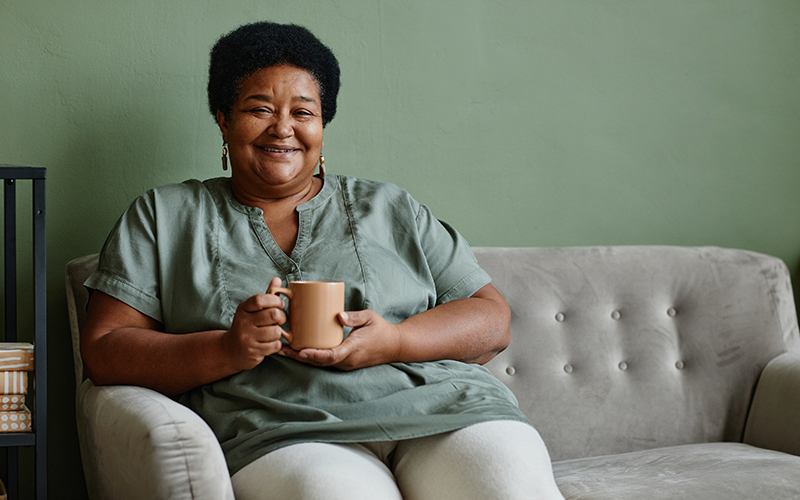 senior lady on couch with coffee mug