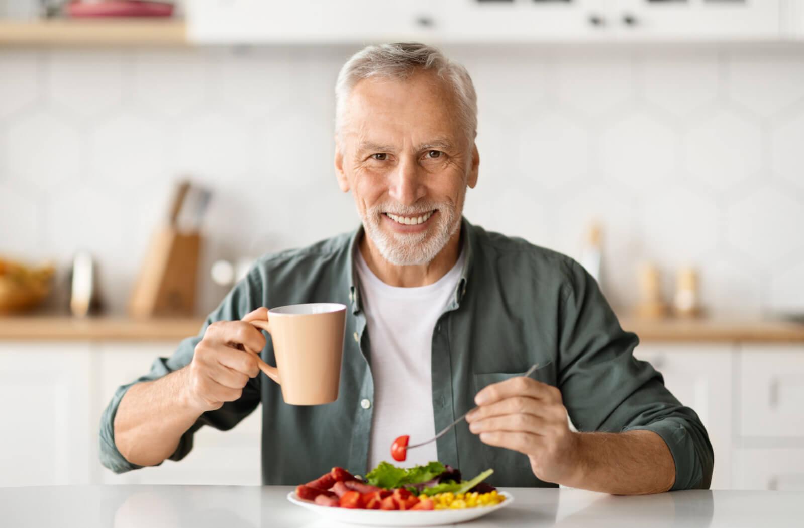 An older adult man enjoying a healthy meal.