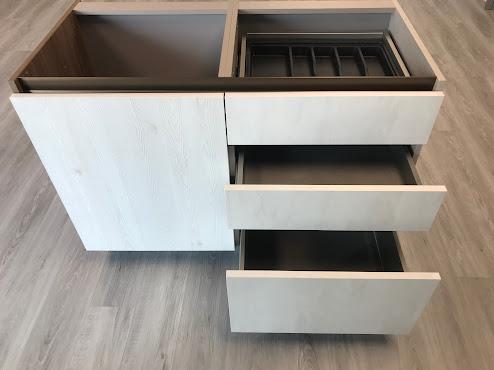 A white cabinet with drawers

Description automatically generated