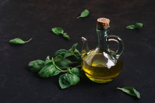 Free photo bottled olive oil with spinach around it