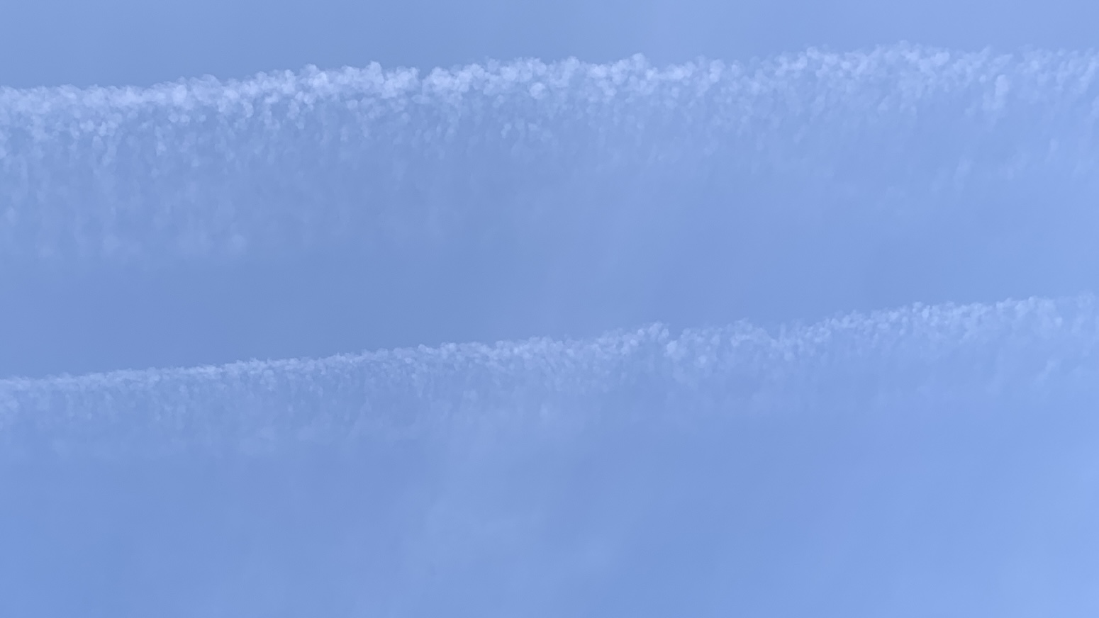 A pale-ish blue weird horizontal streaks of cloud