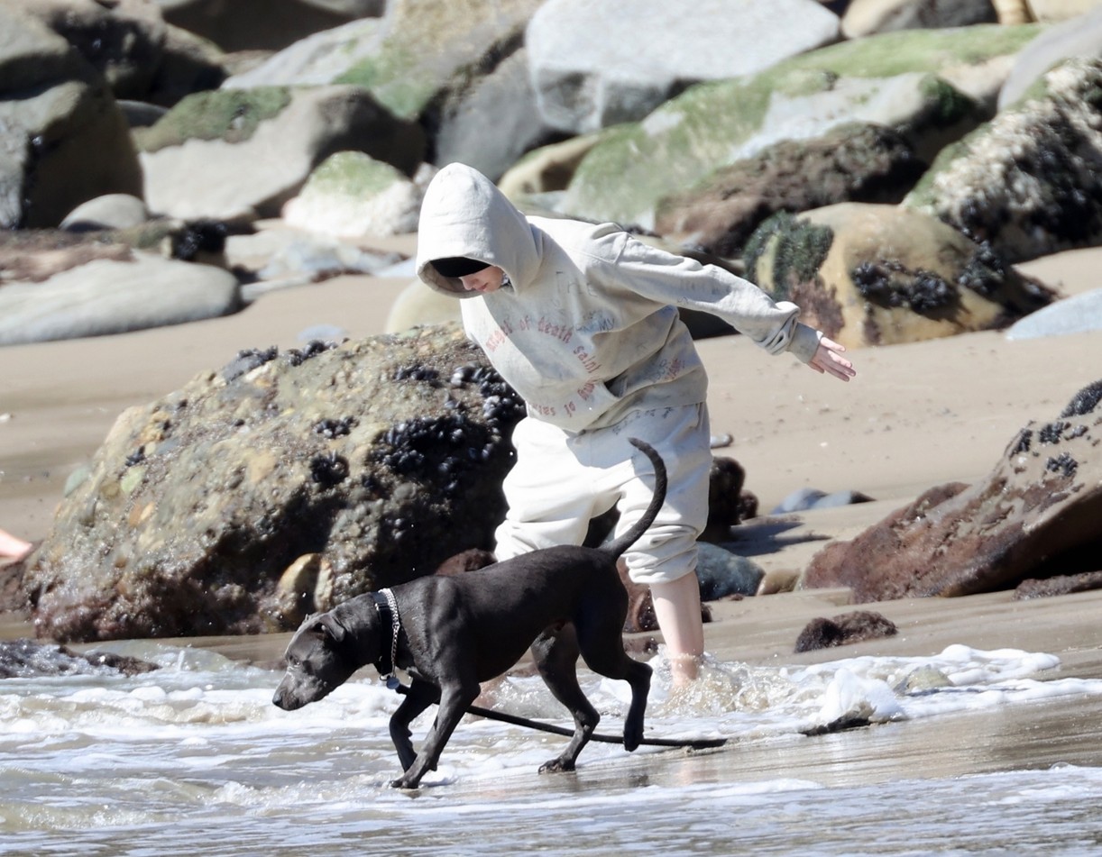 Billie Eilish and her dog named Shark on the beach