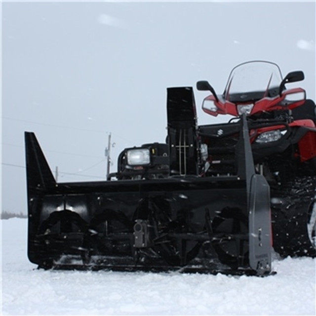 A front-oblique image of the Polaris Ranger with a Bercomac Snowblower attached, riding on a snowy landscape