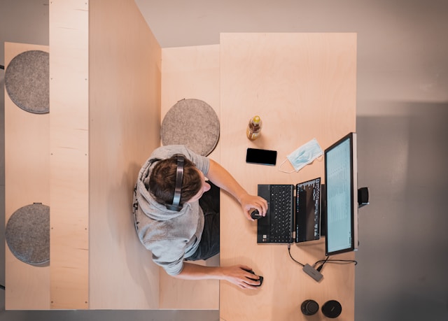 A person working remotely in their designated work desk-The role of human anthropometry in architecture and interior design holds utmost importance.