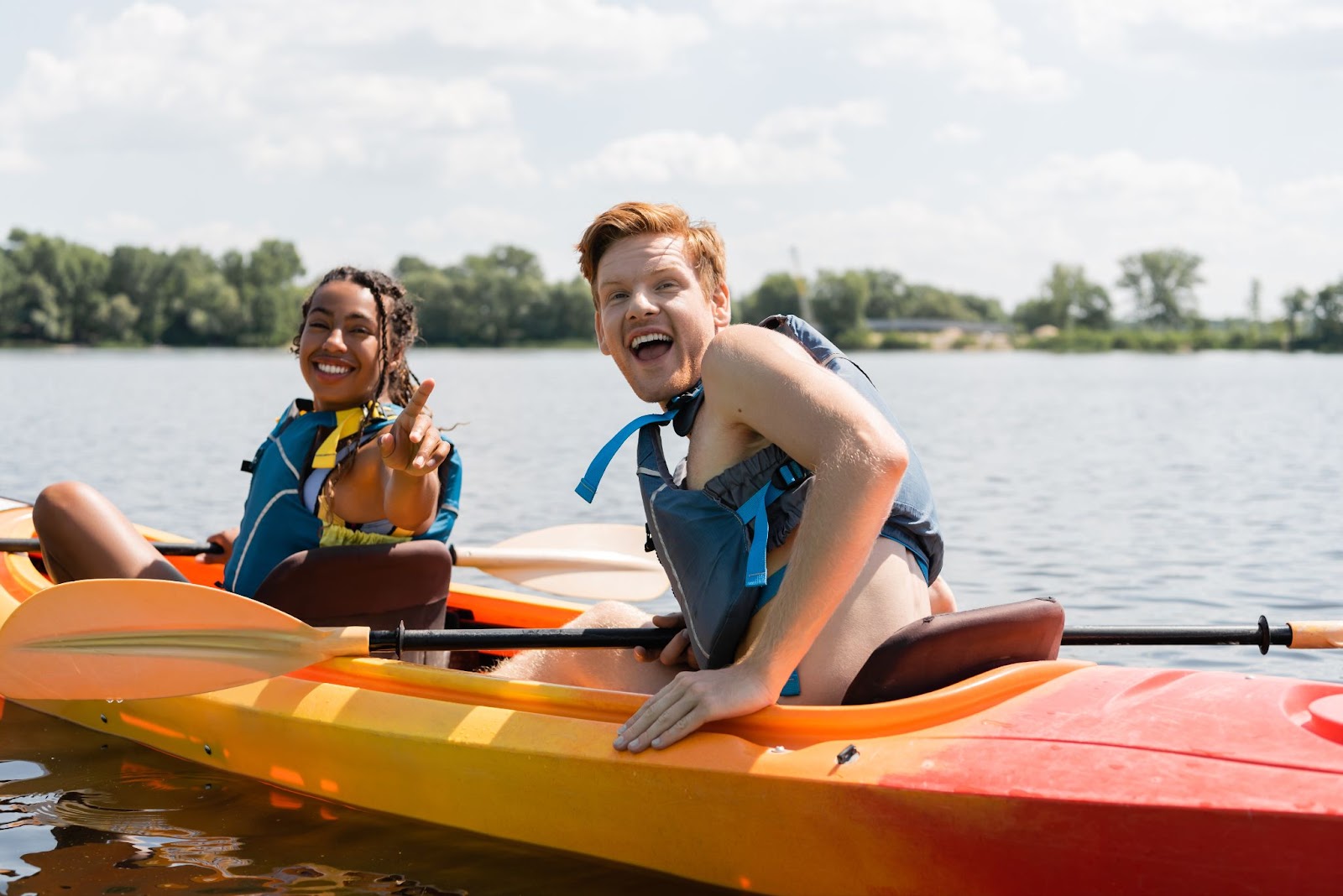 Two friends are kayaking at the beach