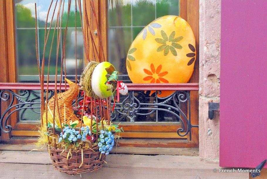 A basket with flowers and eggs on a window sill

Description automatically generated