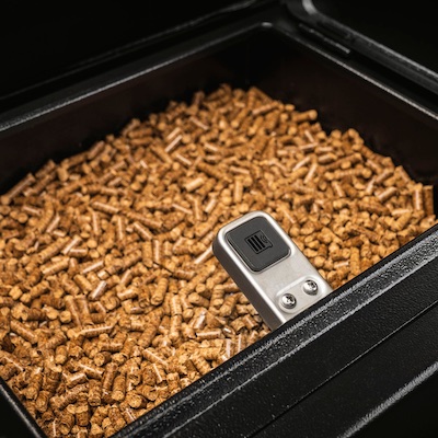 Wood pellets in a pellet grill hoper with view of sensor checking the state of hoper capacity.