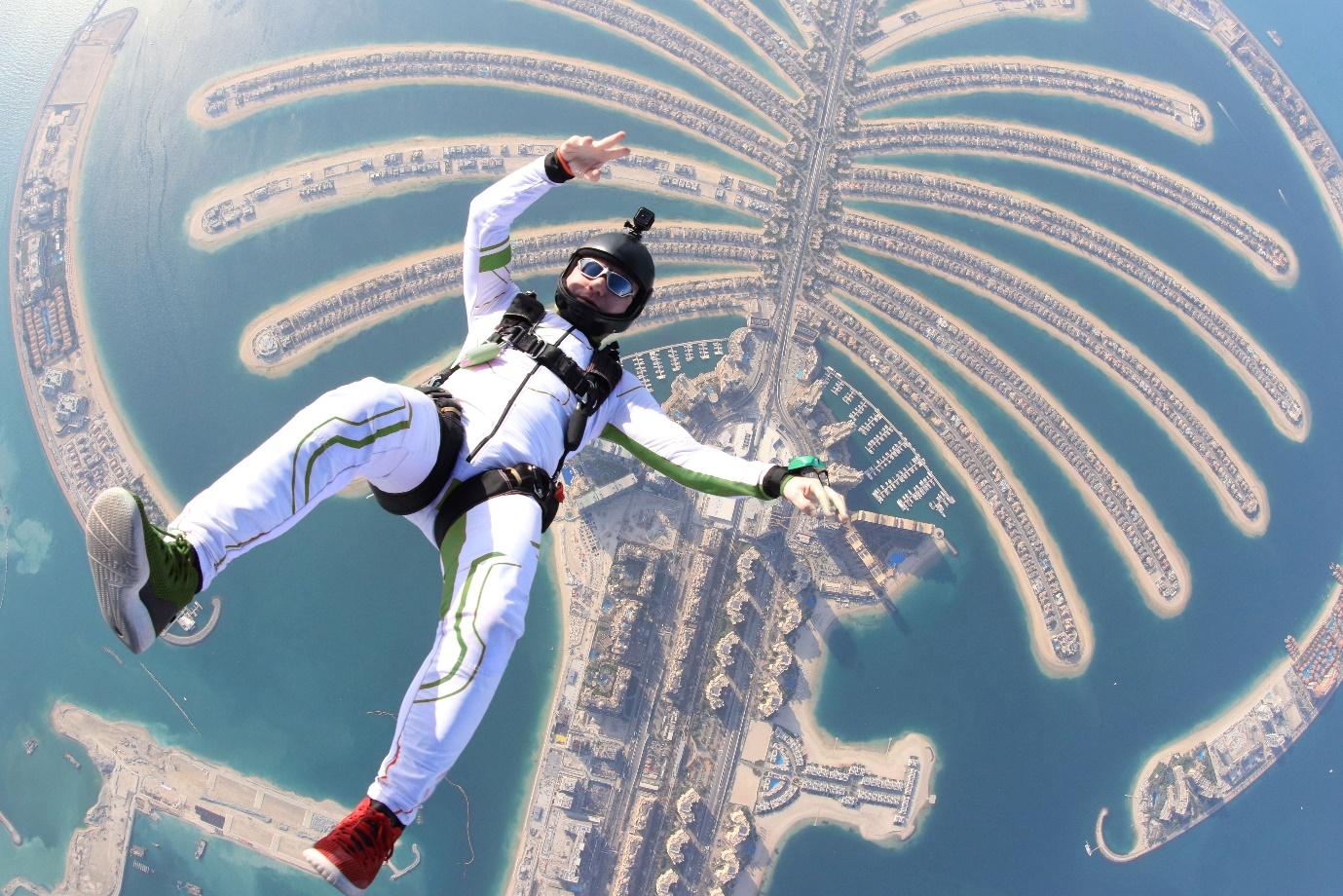 A person skydiving over a city

Description automatically generated