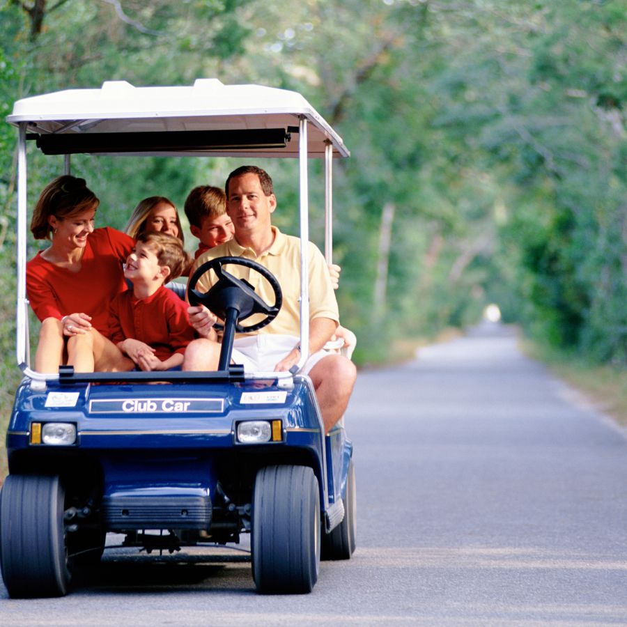 family on golf cart