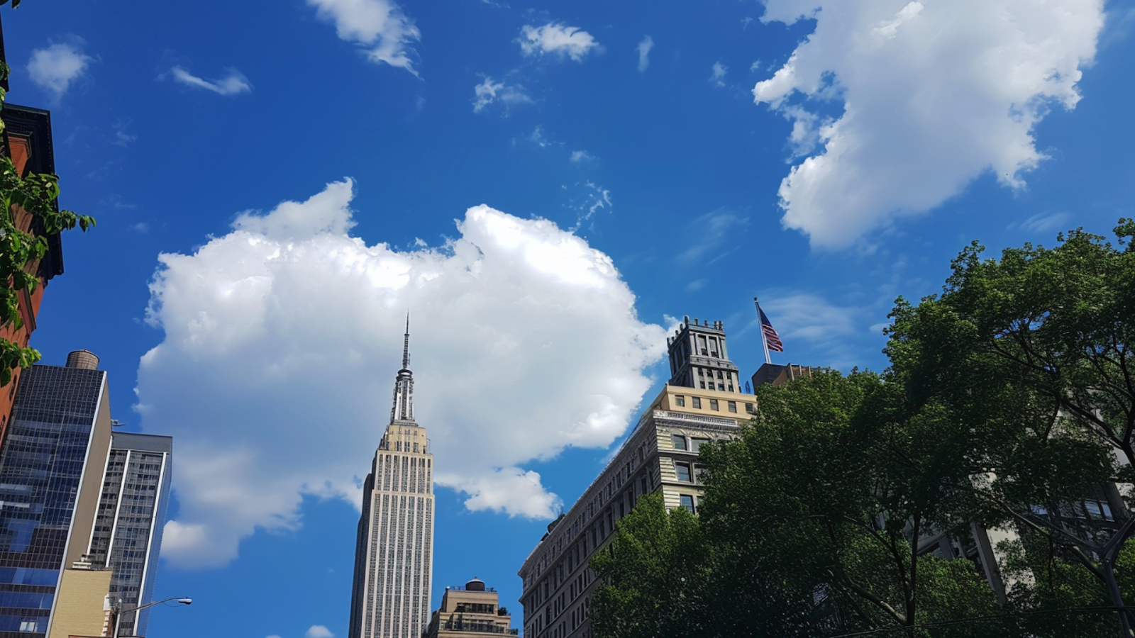 The Empire State Building in New York City underneath blue, cloudy skies