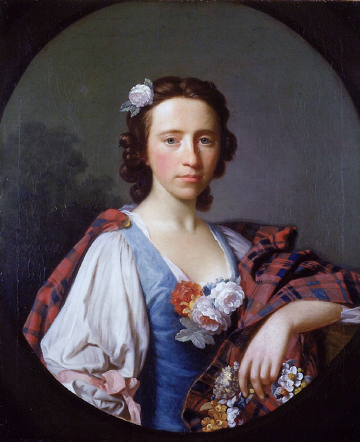 Flora MacDonald.  Her hair is pulled back with curls down her nape.  She is holding a wreath of flowers and has a white rose in her hair. She is wearing a blue overdress with a white undershirt with long billowy sleeves tied at the elbow with a pink ribbon.  There is a bouquet of white roses in the center of the neckline. A tartan is pinned on one shoulder and draped around the opposite  arm. The tartan colors appear to be a red or orange with a dark blue overcheck.
