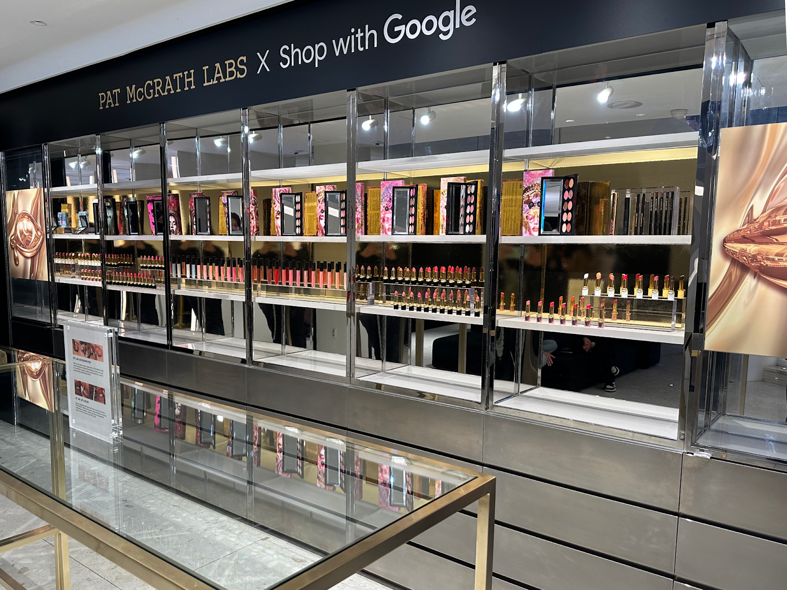Makeup merchandise display with lip prodcuts that reads "Pat McGrath Labs X Shop with Google"