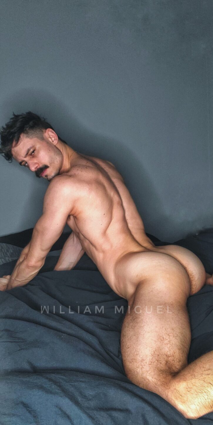 william miguel posing naked on the bed looking over his shoulder showing off his hard muscled ass