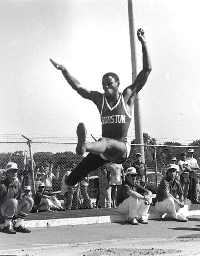 spotcovery-Carl Lewis in midair during a long jump for track and field as an athlete at the University of Houston.