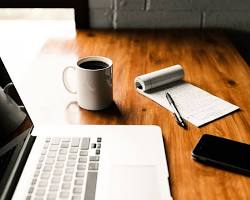 blogger working on their laptop with a cup of coffee