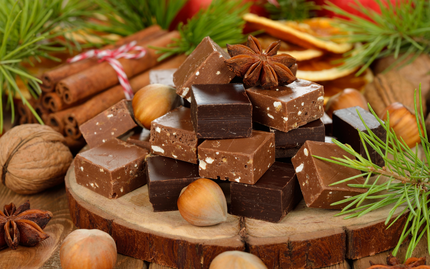 A pile of chocolate on a wood surfaceDescription automatically generated