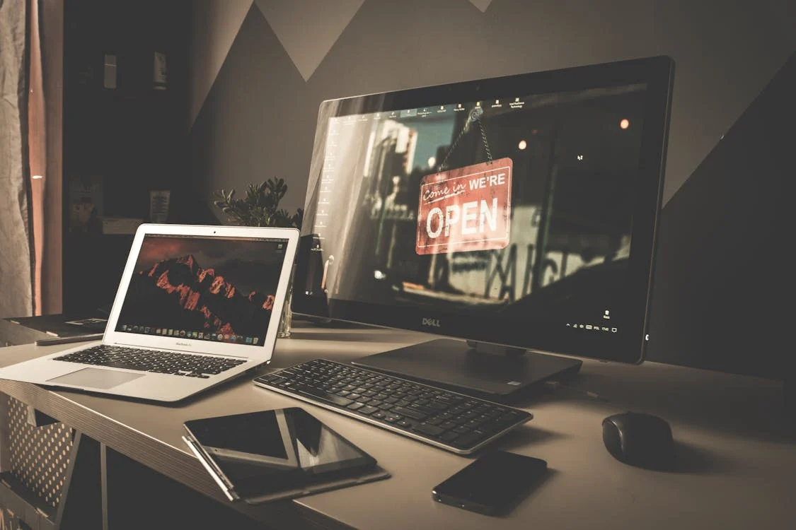 A larger computer screen, laptop, tablet, and smartphone