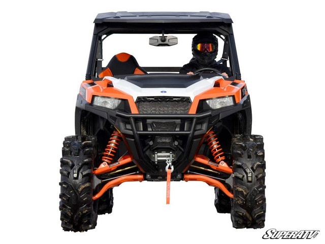 A front-facing image of a Polaris General, lifted 3" using the Polaris General 1000 3" Lift Kit by SuperATV, with a driver inside, all against a blank background.