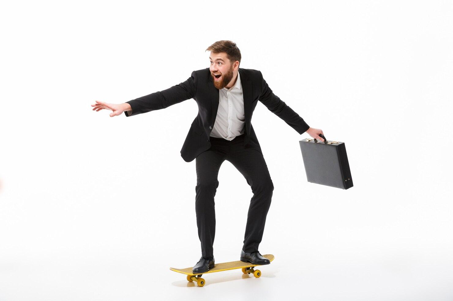 A businessman with a briefcase on a skateboard.