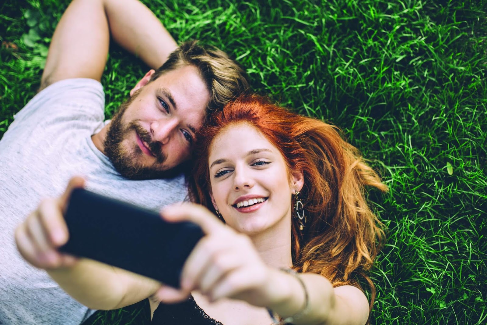 couple lying on the grass