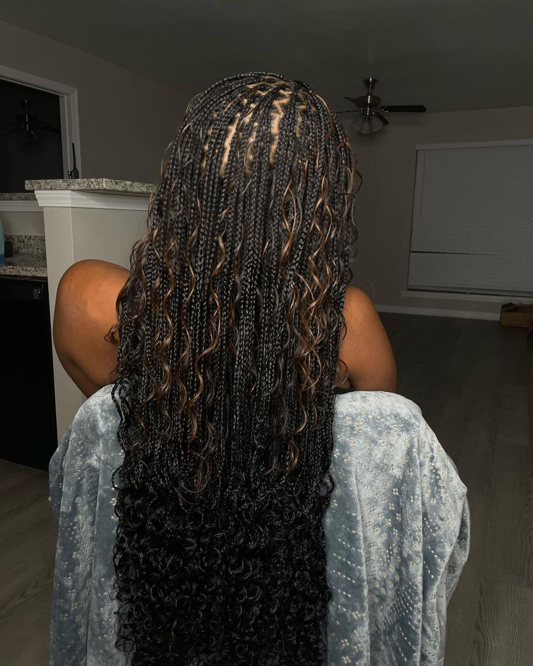 Back view of  a lady showing off her gorgoeus  ,mini boho knotless braids   
