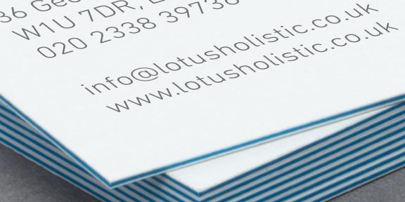 Close-up of a stack of business cards

Description automatically generated