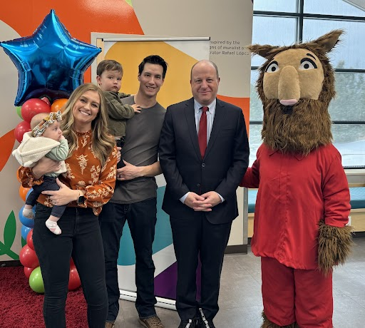 Governor Polis, recipients of the one millionth Imagination Library bookin Colorado, and children's character Llama Llama pose for photo.