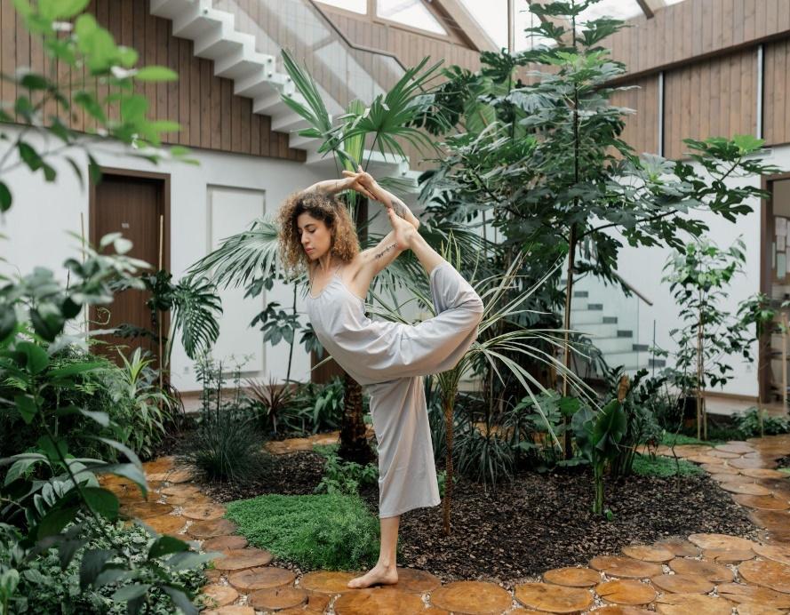 A person doing yoga in a gardenDescription automatically generated
