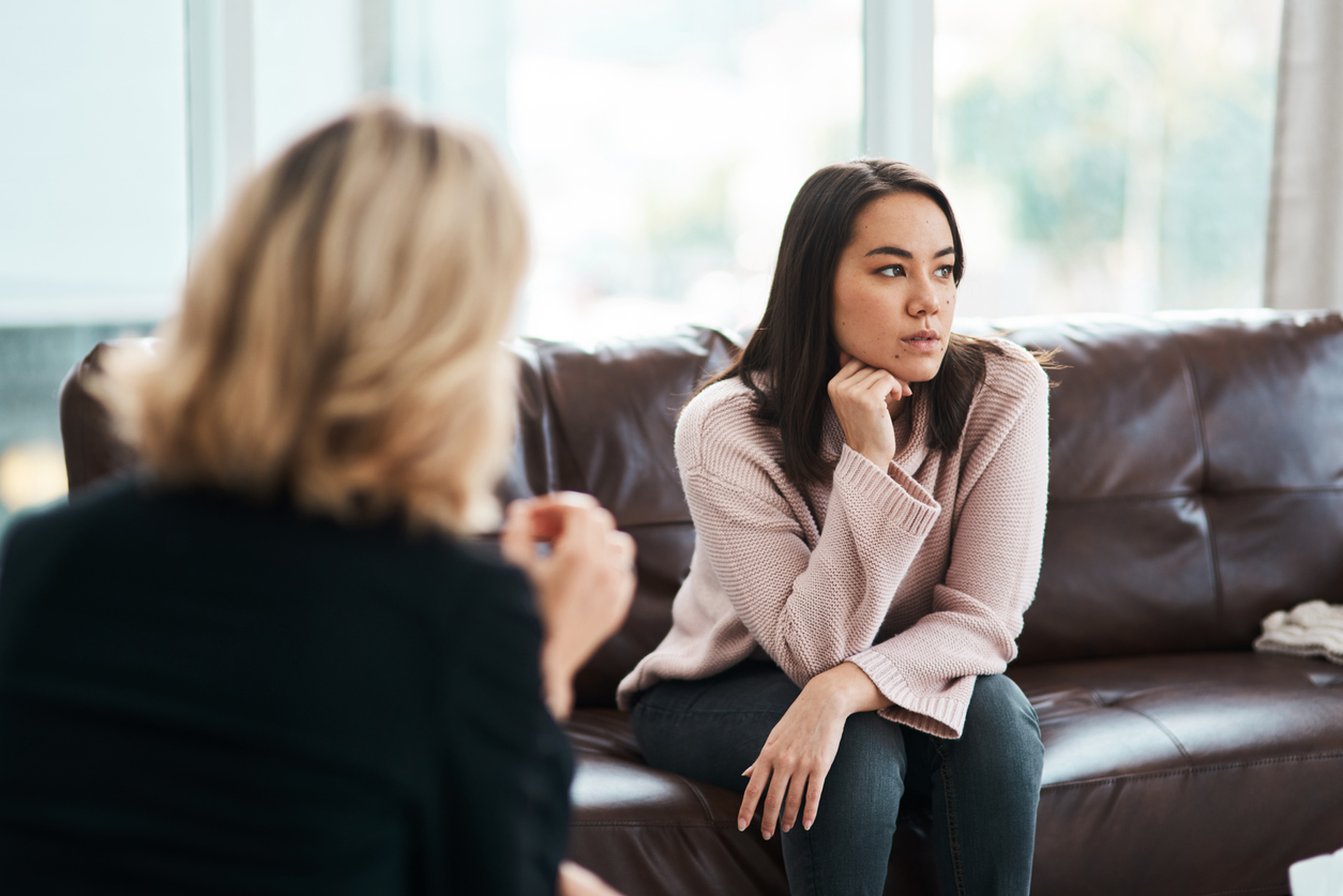 woman not listening in blouse as other woman speaks