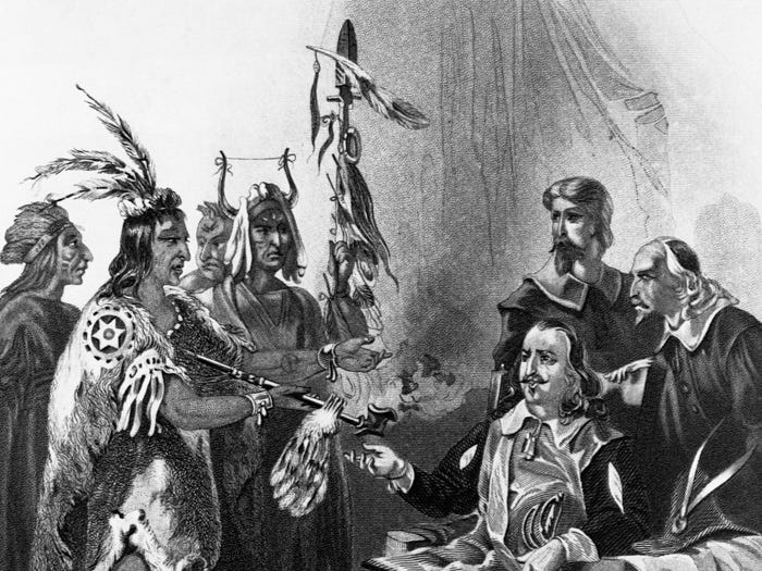 A drawing of Massasoit meeting with Gov. John Carver with other men nearby.