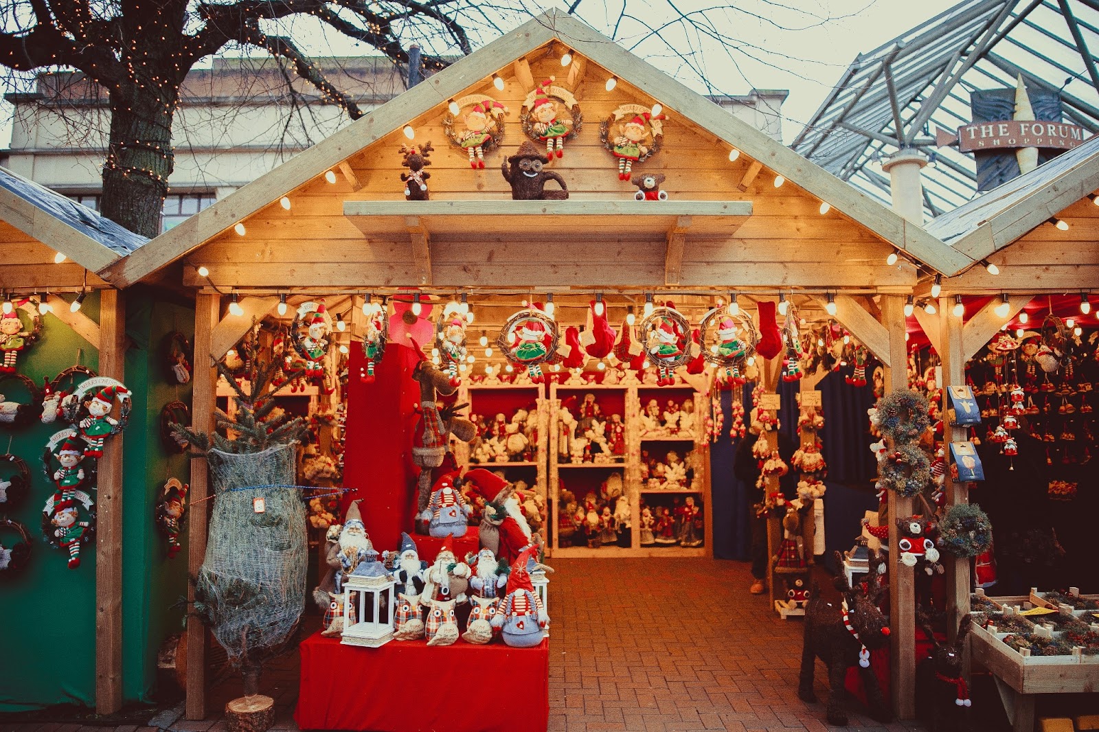 Traditional wooden toys and hand-painted ceramics displayed at a European Christmas market.