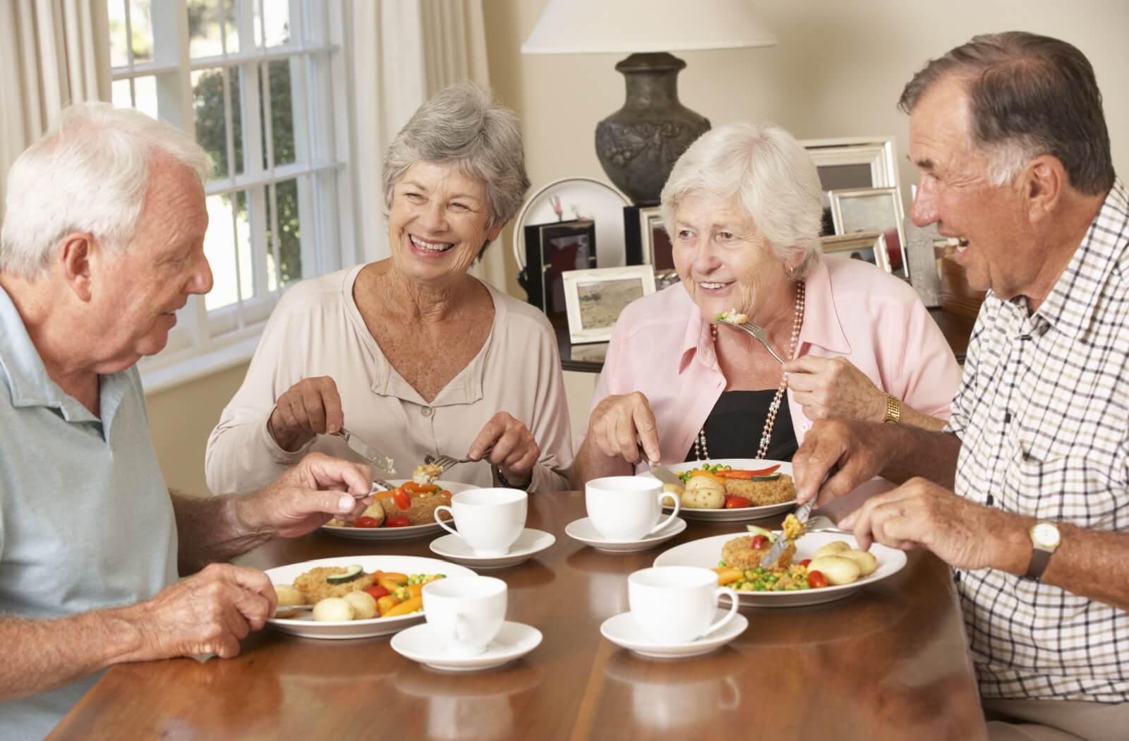 A group of happy seniors sharing a healthy meal together.